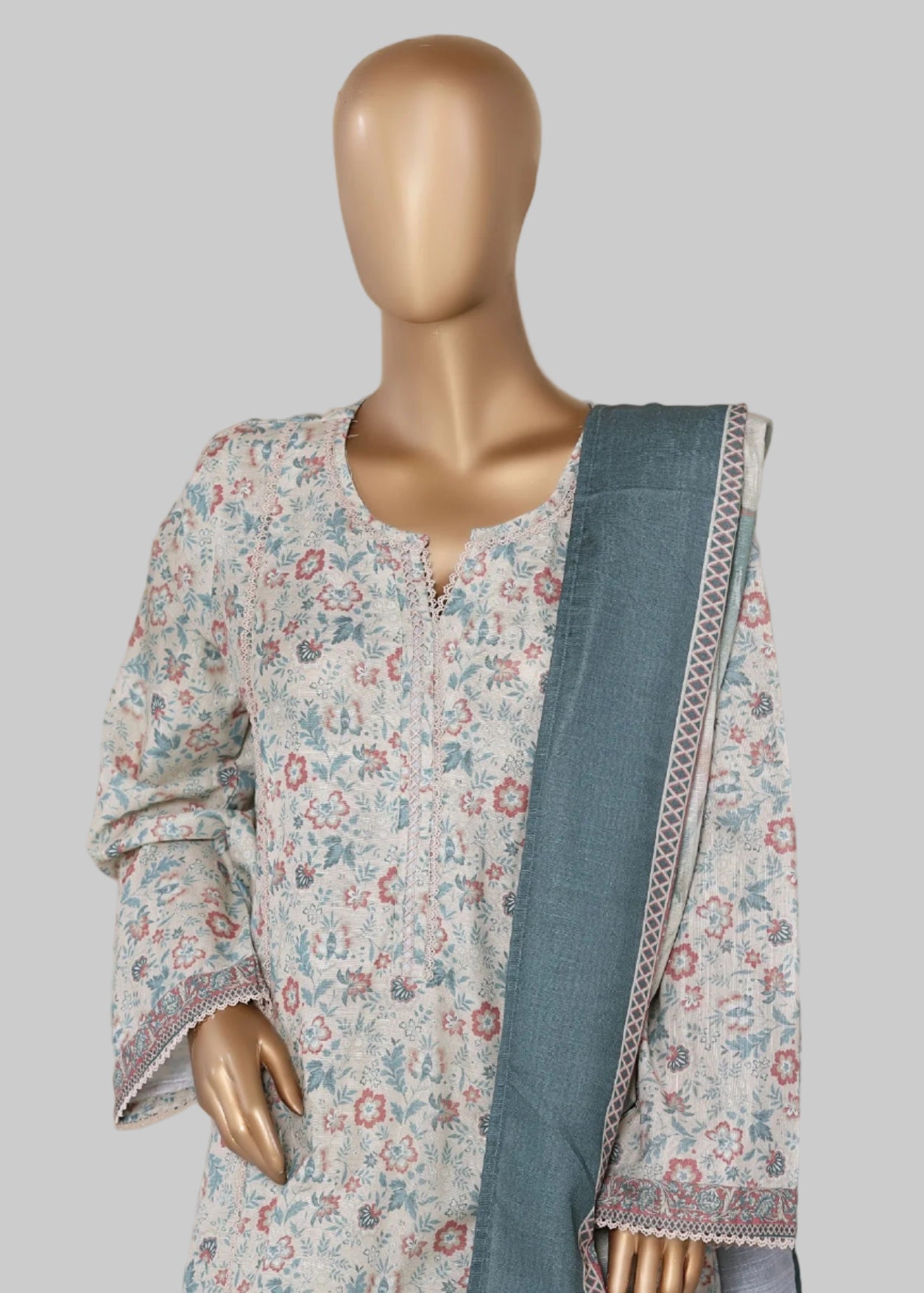 Mannequin wearing a floral dress with a blue dupatta against a beige curtain background, with 'The Floral Romance' text.
