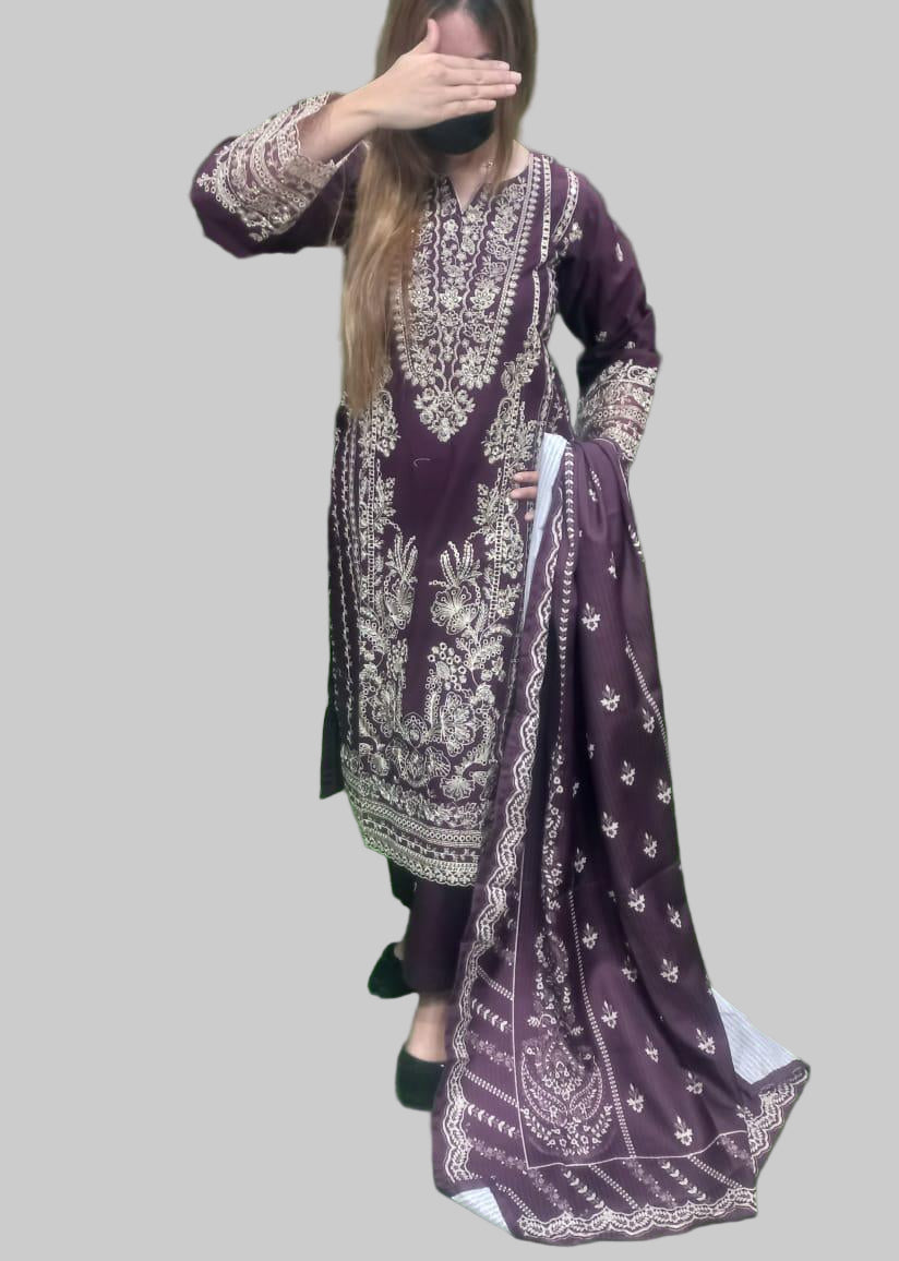 Person wearing a purple embroidered outfit with a matching dupatta against a green background
