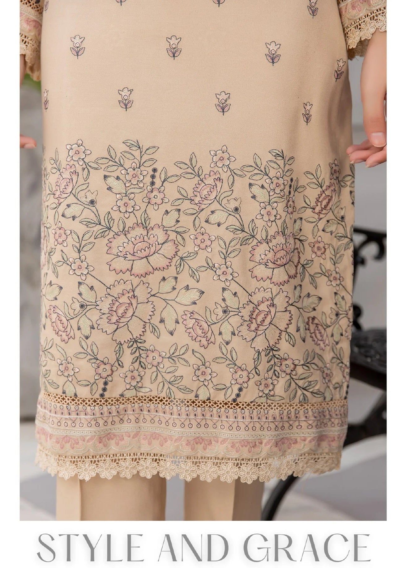 Woman wearing a beige embroidered outfit closeup.