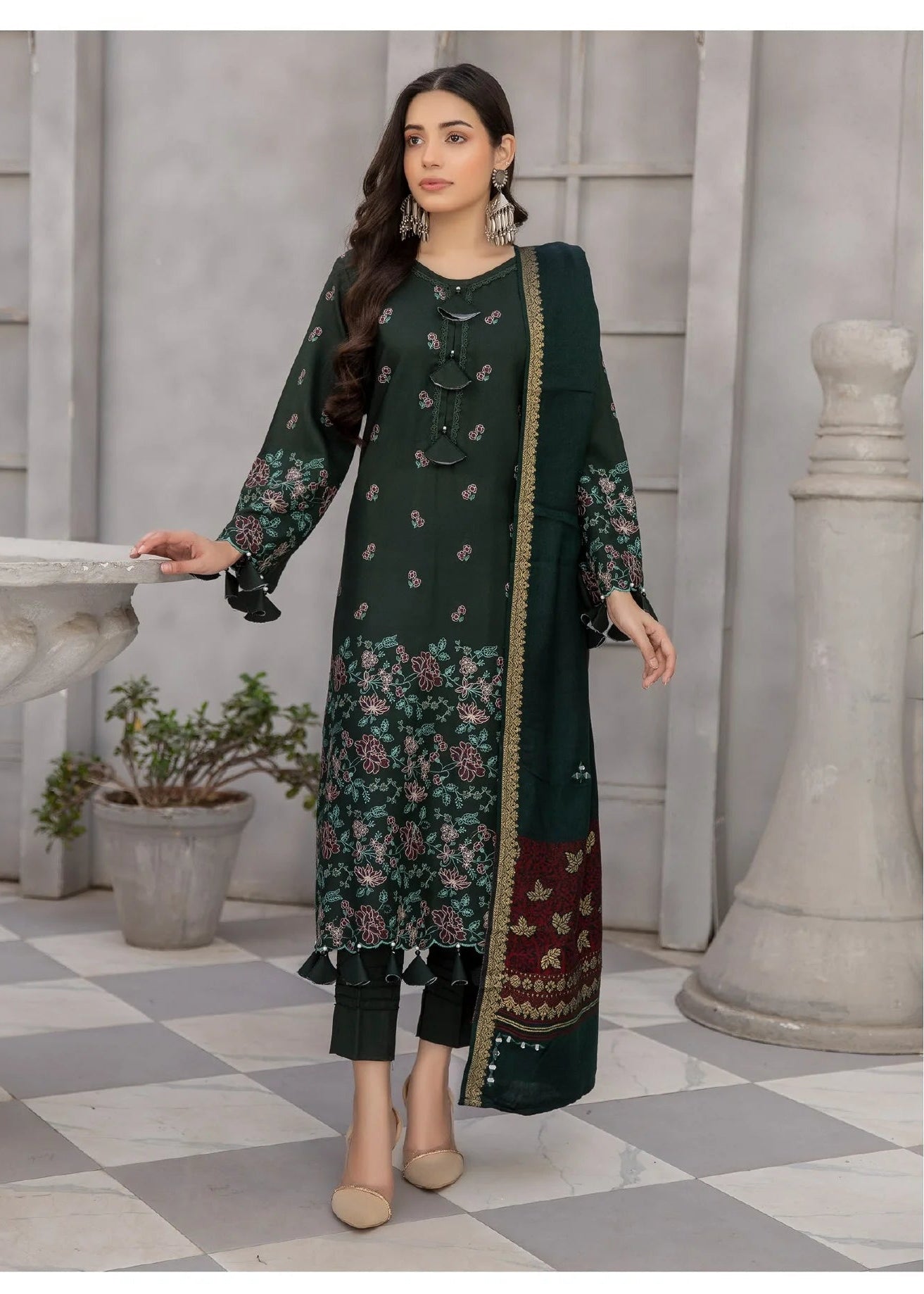 Woman wearing a dark green floral dress with a checkered floor background