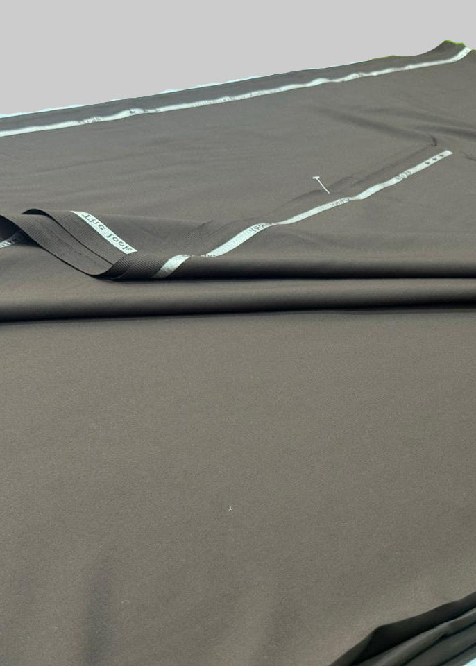 Brown fabric with white stitching on a green surface