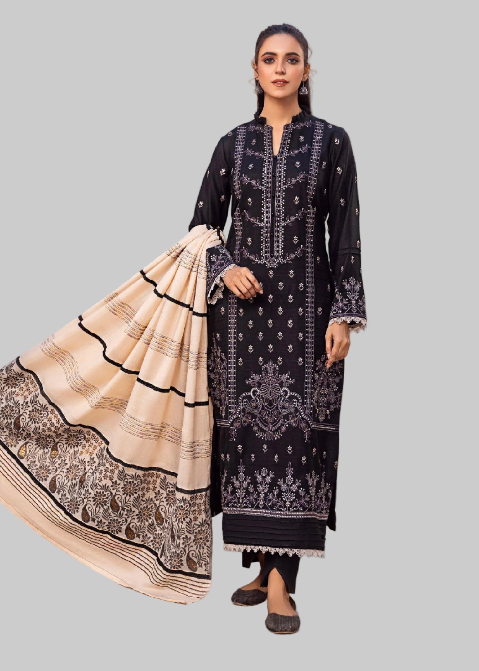 Woman in a black and white traditional outfit with a scenic background.