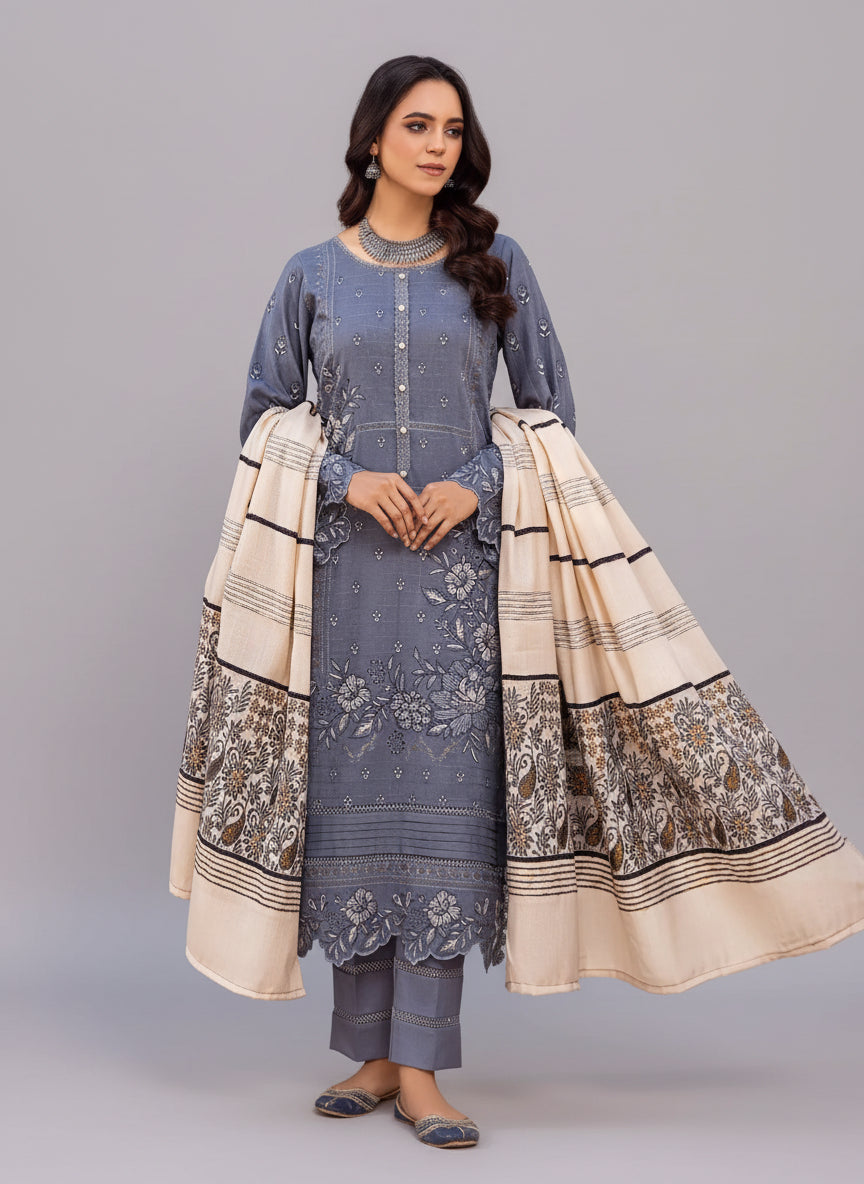 Woman in a blue traditional outfit with a patterned dupatta in a Studio room.