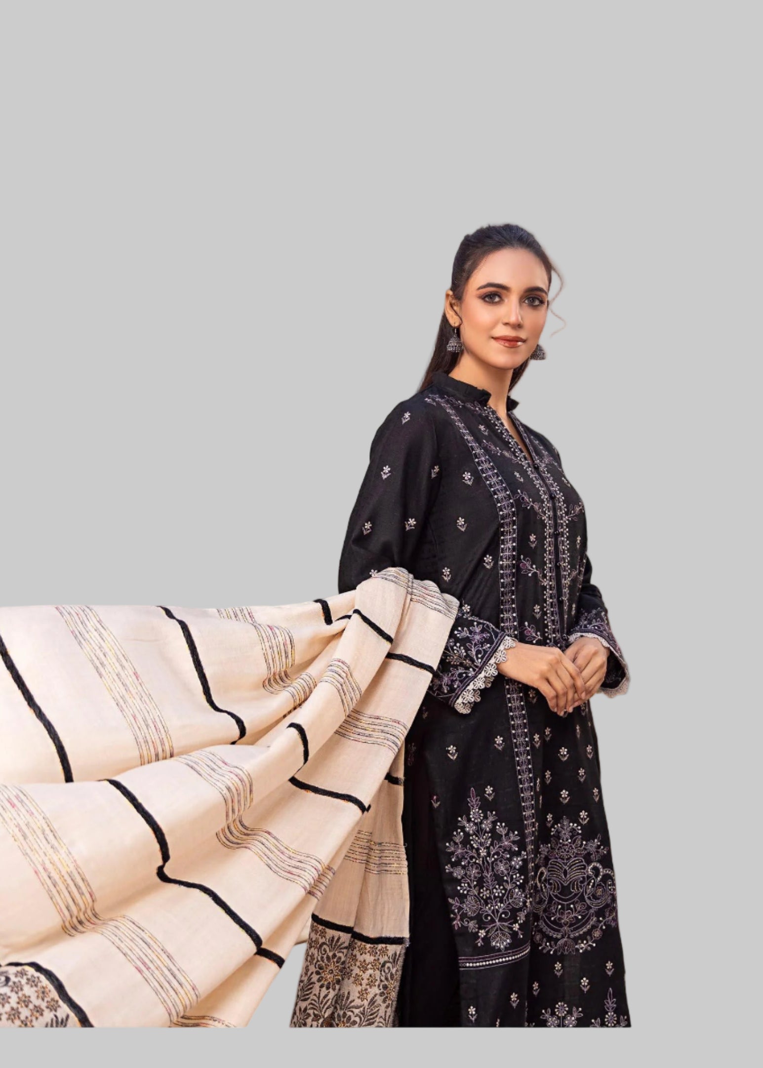 Woman holding a patterned fabric in a Studio room.