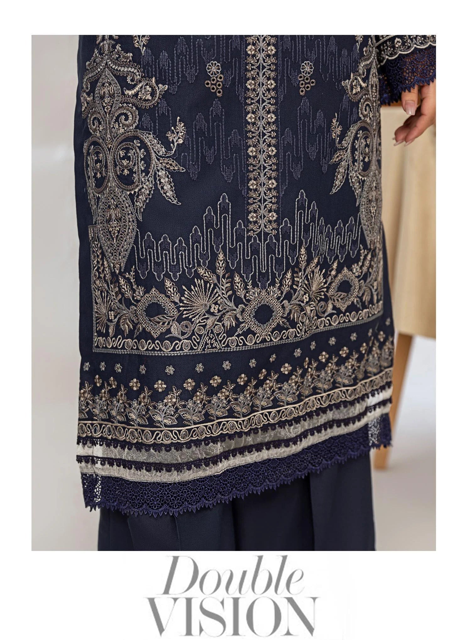 Woman wearing a navy blue embroidered outfit with a close-up of the fabric.