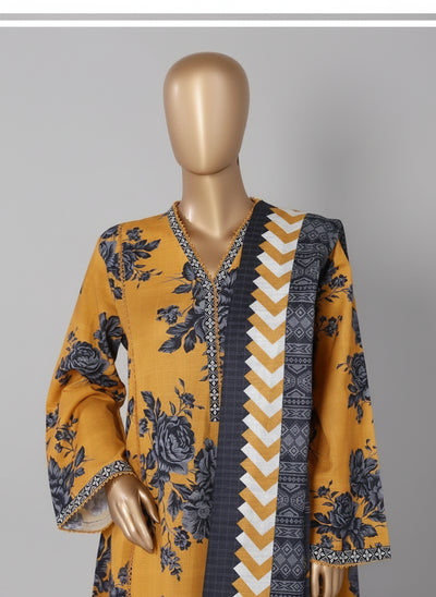 Mannequin wearing a yellow and blue patterned outfit with a decorative chair in the background.