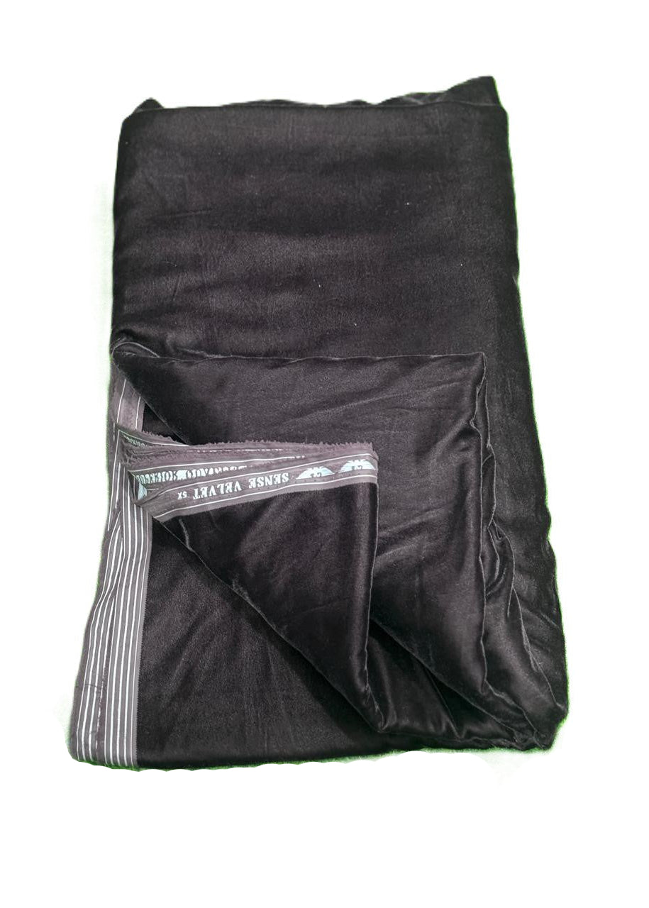 Folded black blanket with a brand label on a white background