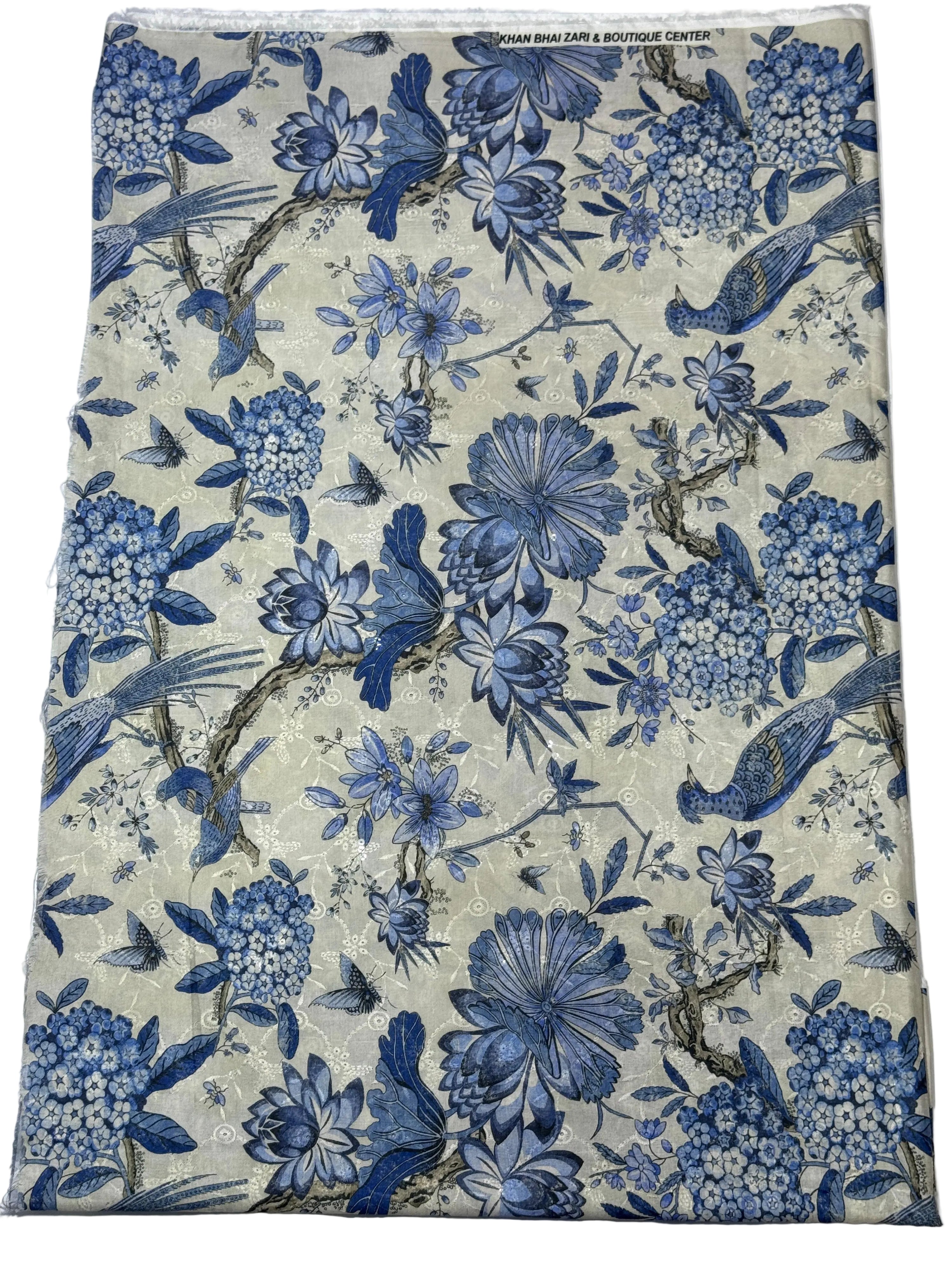 Fabric swatch with blue floral and bird pattern on a White background