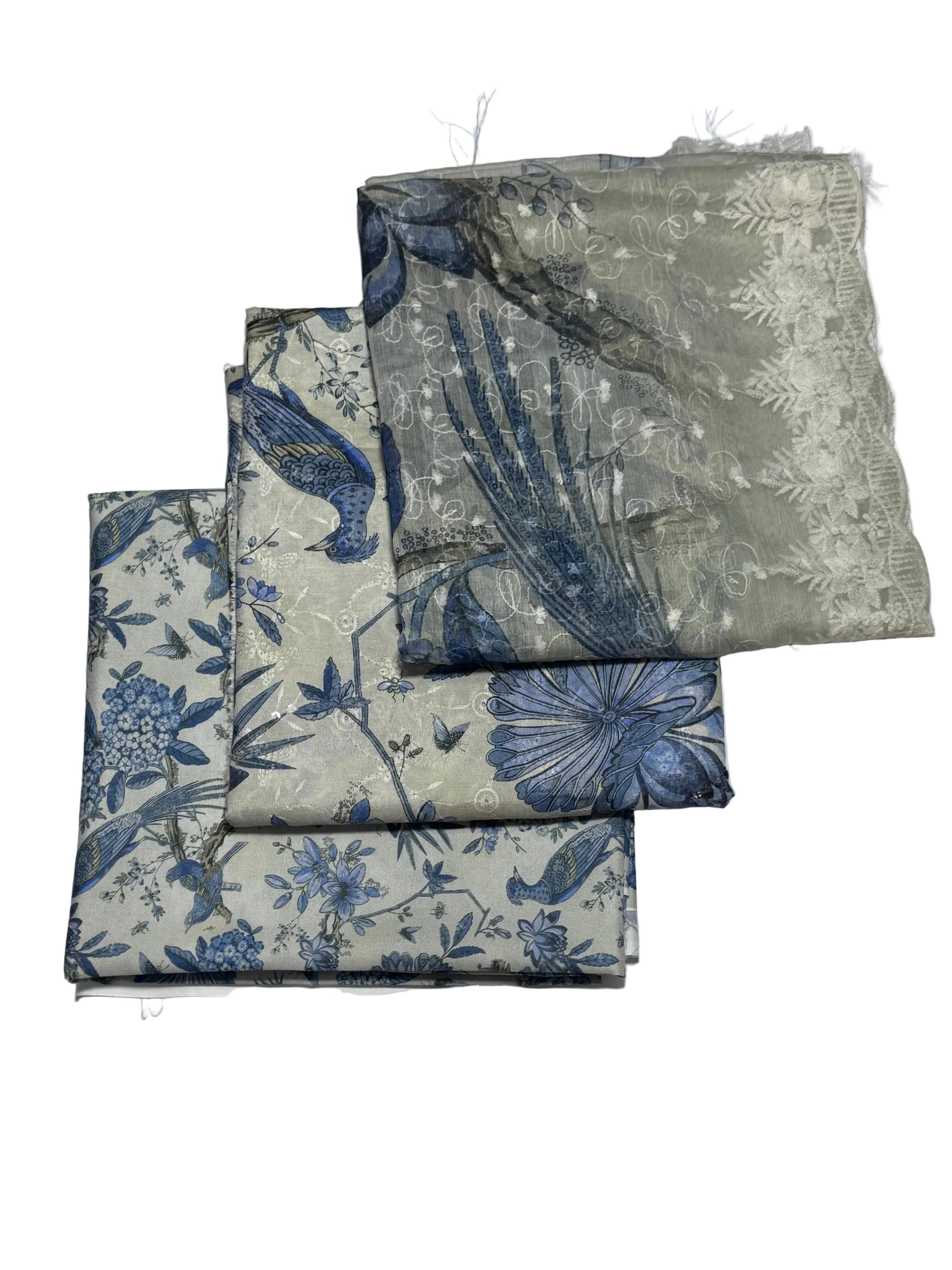 Set of floral and bird patterned napkins on a white background with yellow flowers.