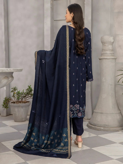 Woman wearing a navy blue traditional outfit with a matching dupatta in an indoor setting.