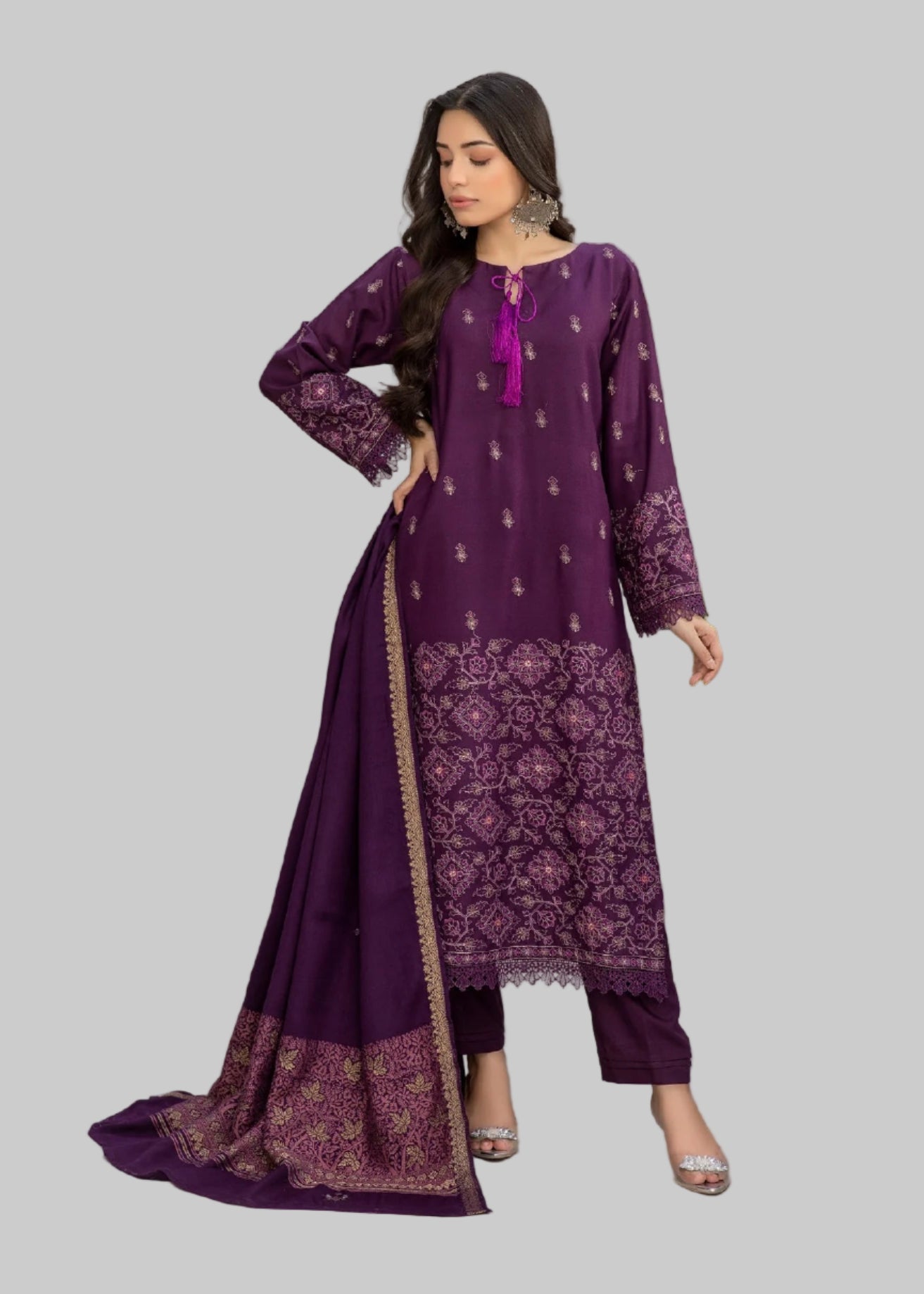 Woman wearing a purple embroidered outfit with a close-up of the fabric, set against a neutral background.