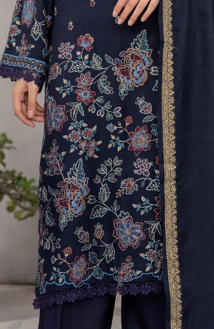 Woman wearing a navy blue embroidered outfit sitting on a bench, with close-up details of the fabric.