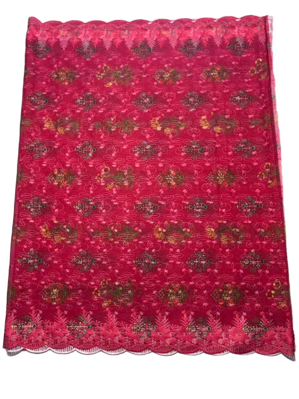 Red fabric with gold floral patterns on a white background