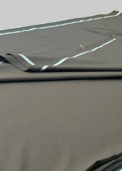 Brown fabric with white stitching on a green surface
