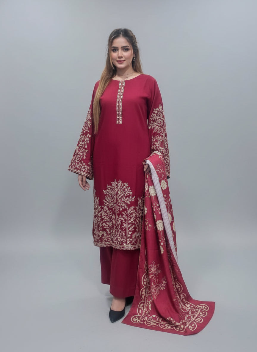 A women wearing a red traditional outfit with white embroidery in a green room.