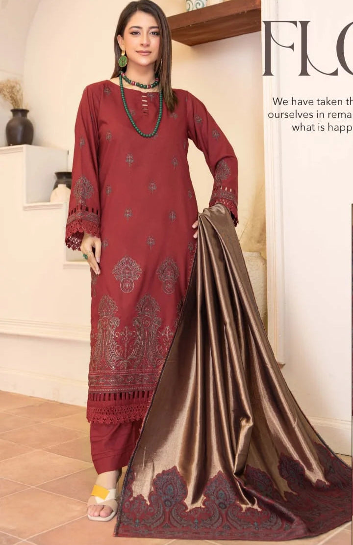 Woman wearing a red and gold traditional outfit with a scarf in a room.