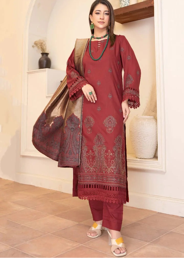 Woman wearing a red embroidered traditional outfit in a decorative room.