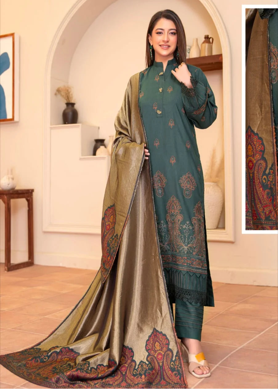 Woman wearing a green and beige traditional outfit with a patterned dupatta in a room setting.