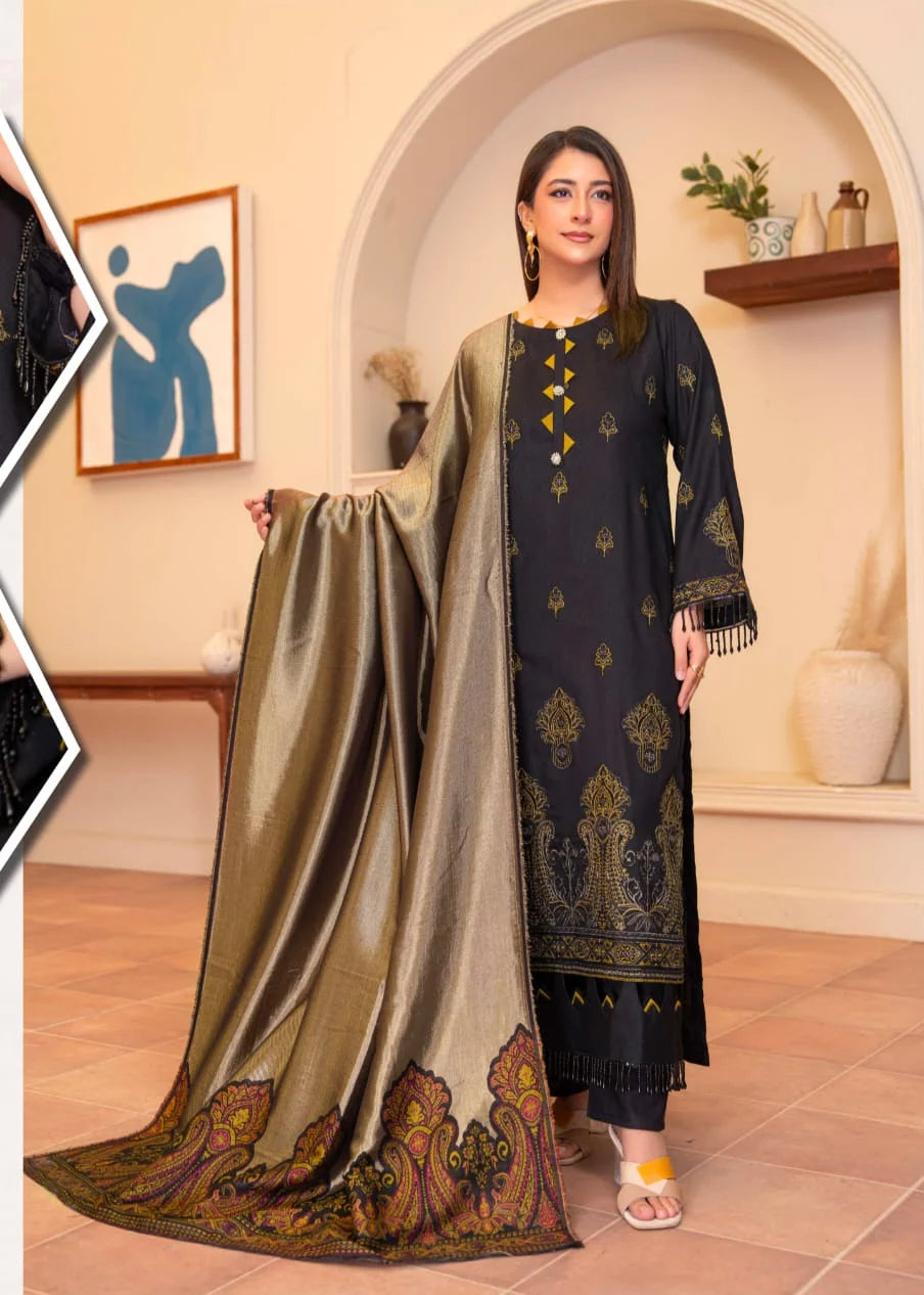 Woman holding a traditional outfit with a decorative shawl in a well-lit room.