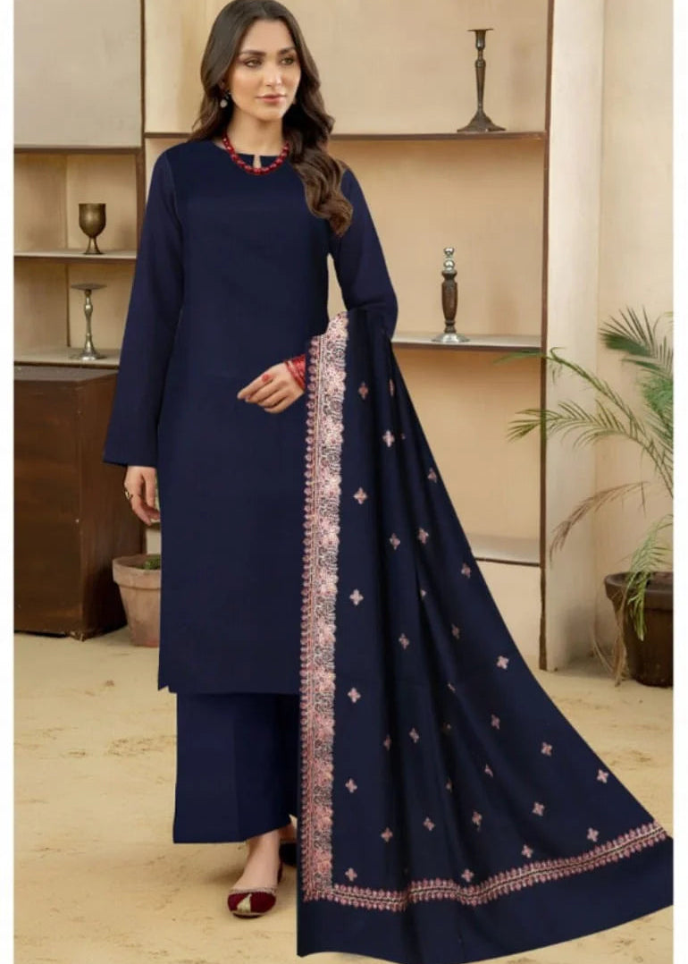 Woman wearing a navy blue traditional outfit with a matching dupatta in an indoor setting.
