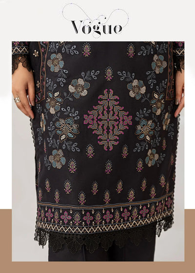 Woman wearing a black embroidered outfit with a matching scarf, with 'Vogue' branding.