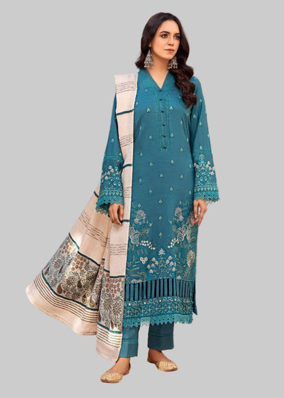 Woman in a blue traditional outfit with a white dupatta in a decorated room.