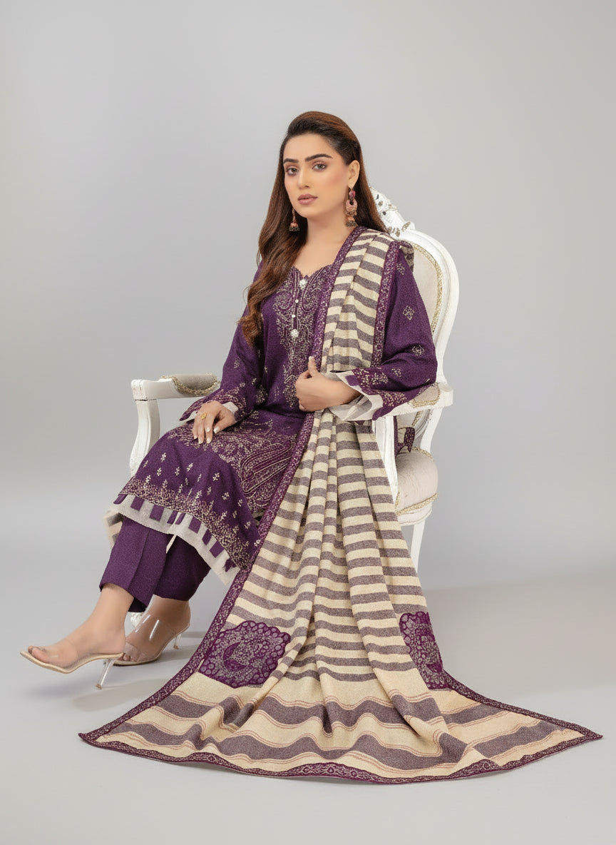 Woman in a purple and beige traditional outfit sitting on a white chair with a fireplace in the background.