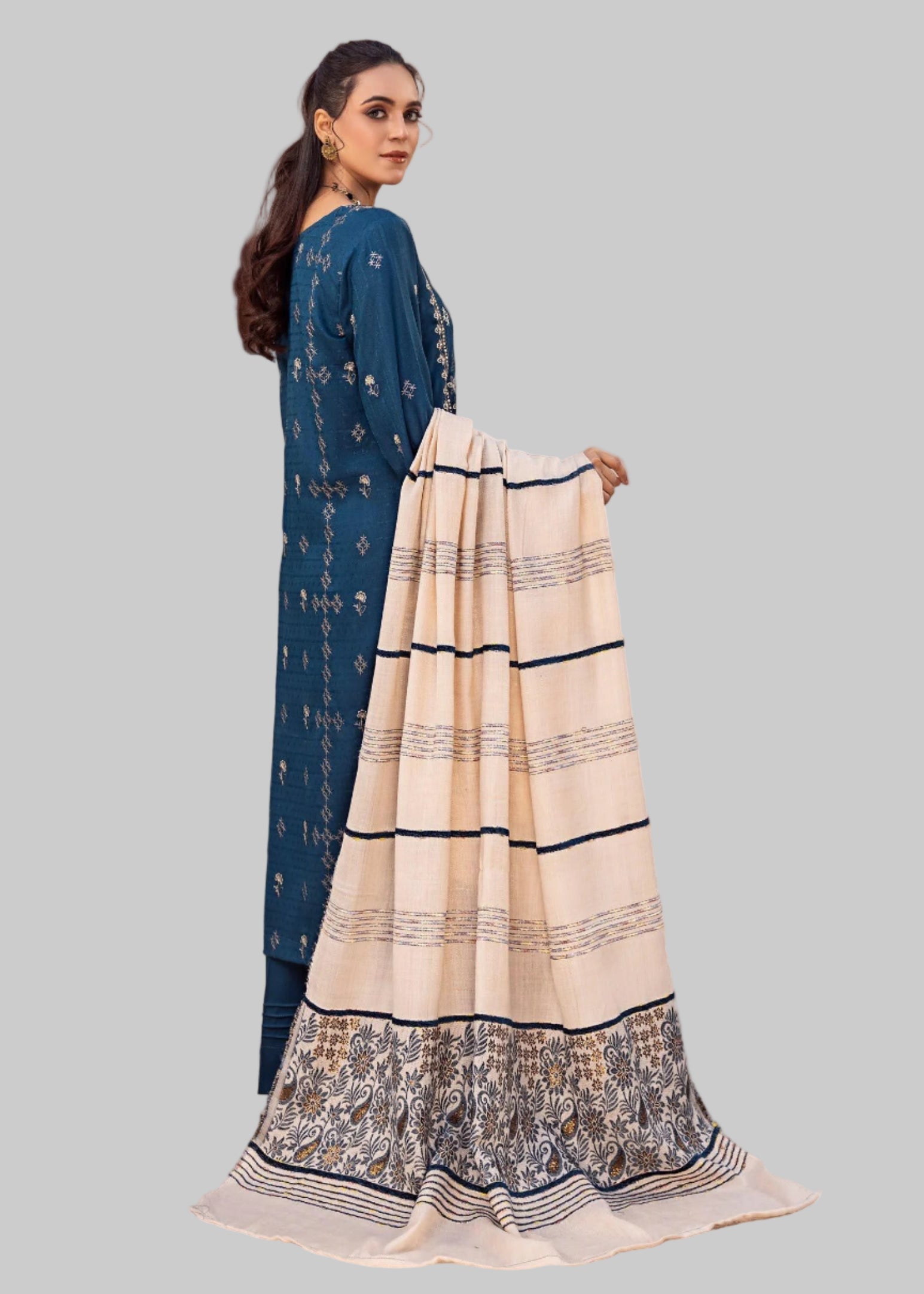Woman modeling a blue and white traditional outfit in Studio a room .