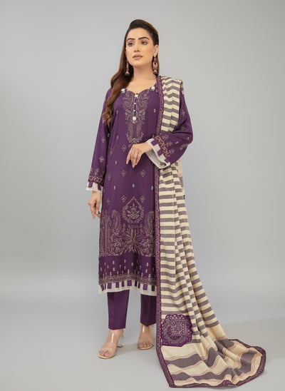 Woman wearing a purple and white outfit with floral patterns in a Studio room.