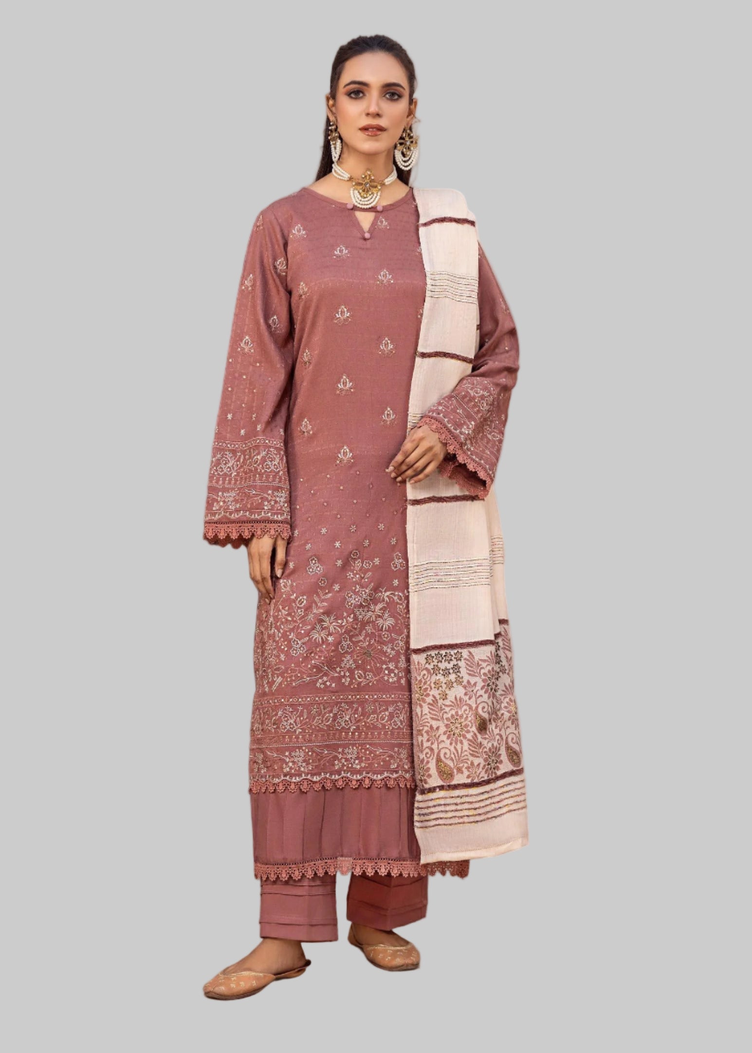 Woman wearing a traditional outfit with a long scarf in a studio room.