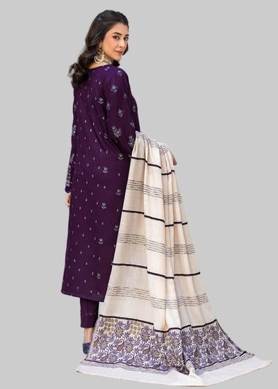 Woman wearing a purple traditional outfit with white patterns in an indoor setting.