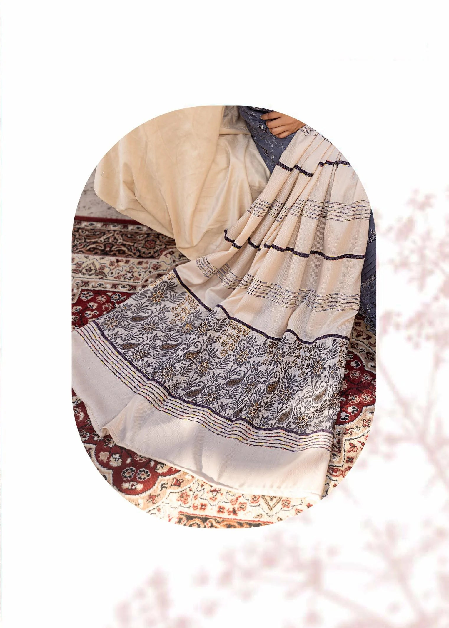 Woman in a blue embroidered outfit with a close-up of the fabric details.