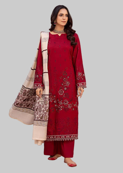 Woman in a red traditional outfit with beige patterns in a decorated room.