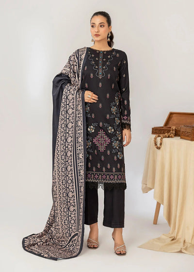 Woman wearing a black embroidered outfit with a patterned dupatta on a white background