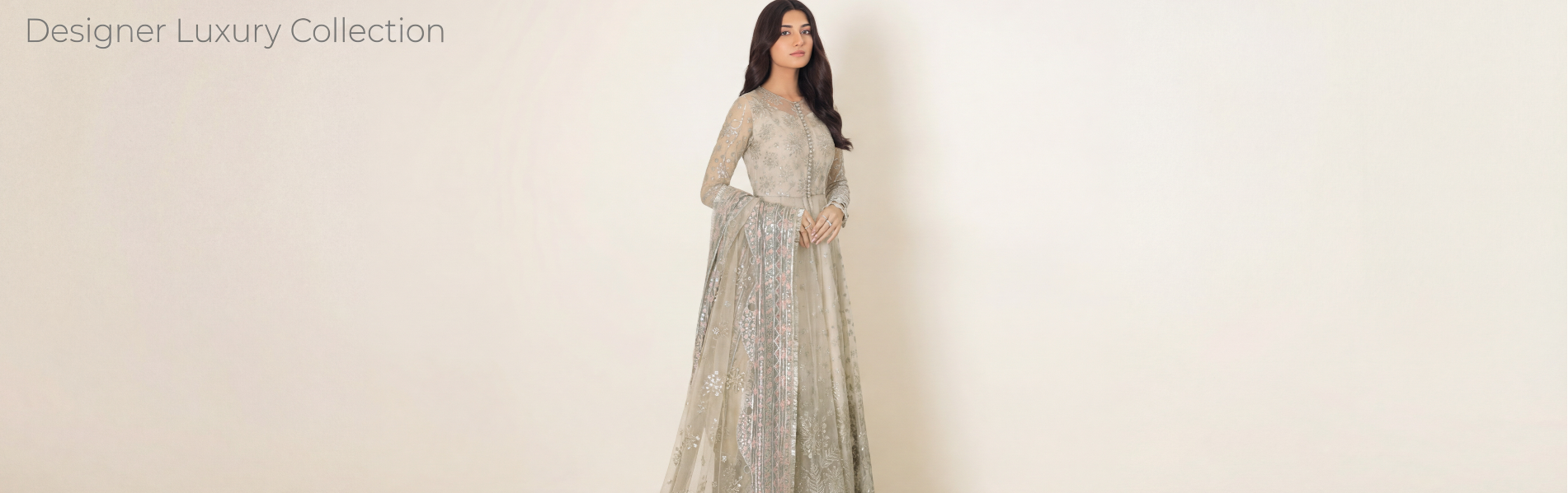 Woman wearing a silver evening gown against a white background